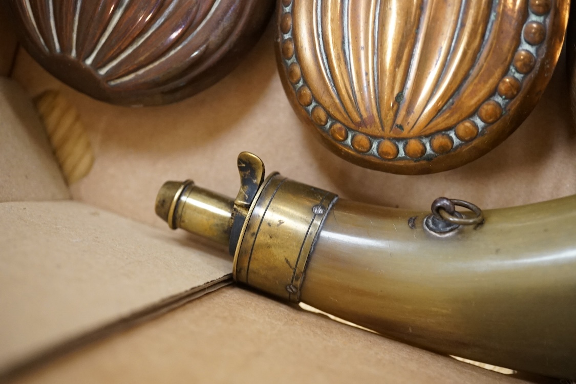 Nine powder flasks and shot flasks, all 19th century, comprising of two horn flasks, one flattened with brass mounts, three shot bags with sprung brass chargers, three copper gun flasks and another of zinc